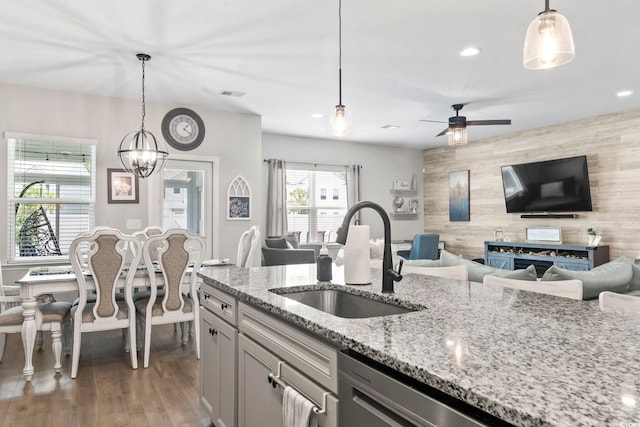 4927 Sandlewood Dr, Myrtle Beach, SC 29579 - kitchen with a sink, open floor plan, wooden walls, ceiling fan, and light stone countertops