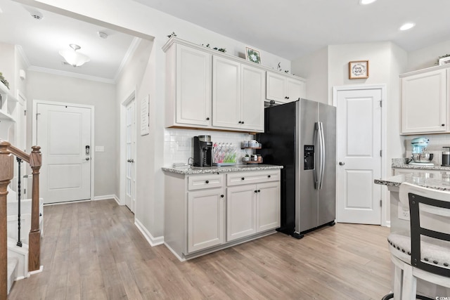 4927 Sandlewood Dr, Myrtle Beach, SC 29579 - kitchen with stainless steel refrigerator with ice dispenser, decorative backsplash, white cabinets, light wood-type flooring, and ornamental molding