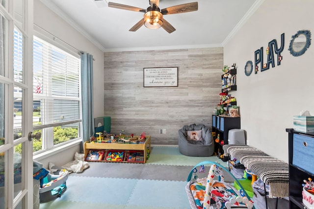 4927 Sandlewood Dr, Myrtle Beach, SC 29579 - playroom featuring an accent wall, healthy amount of natural light, a ceiling fan, crown molding, and wood walls