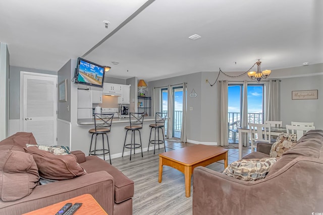 5905 S Kings Hwy Unit 1816Rt, Myrtle Beach, SC 29575 - living room featuring a chandelier, light wood-style floors, and baseboards