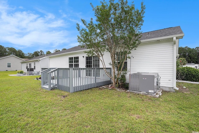 1001 Greencrest Ct, Conway, SC 29526 - back of house featuring cooling unit, a lawn, a wooden deck, and roof with shingles