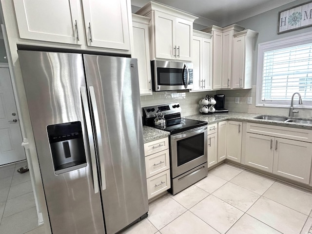 1029 Ray Costin Way Unit 909, Murrells Inlet, SC 29576 - kitchen featuring appliances with stainless steel finishes, a sink, backsplash, light stone counters, and light tile patterned floors