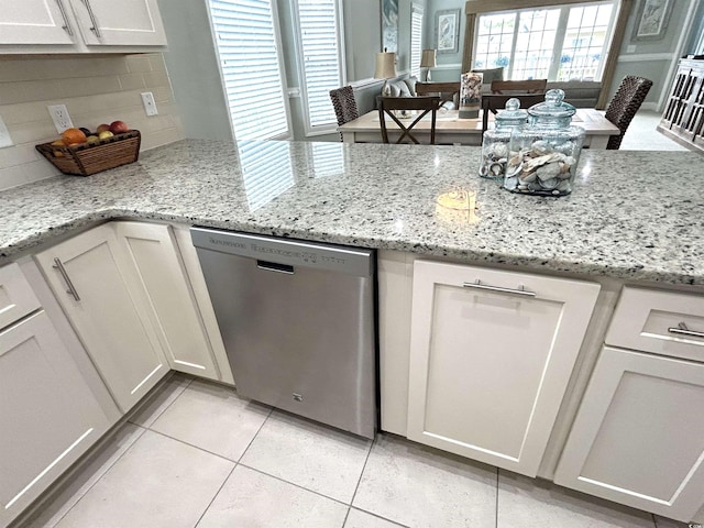 1029 Ray Costin Way Unit 909, Murrells Inlet, SC 29576 - kitchen with dishwasher, light tile patterned flooring, white cabinets, and tasteful backsplash