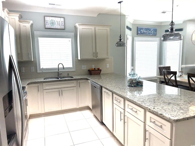 1029 Ray Costin Way Unit 909, Murrells Inlet, SC 29576 - kitchen with a sink, stainless steel appliances, a peninsula, backsplash, and ornamental molding