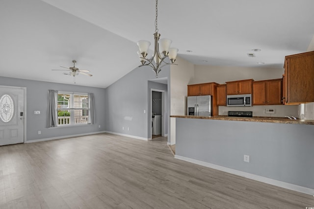 1220 Dunraven Ct, Conway, SC 29527 - kitchen featuring appliances with stainless steel finishes, ceiling fan, brown cabinetry, vaulted ceiling, and light wood-type flooring