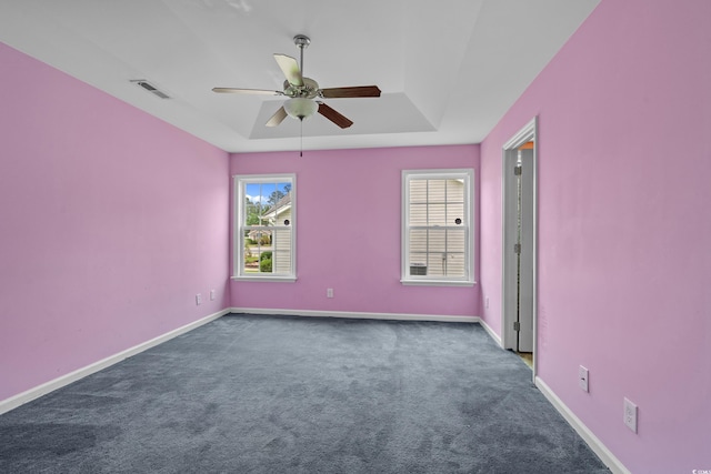 1220 Dunraven Ct, Conway, SC 29527 - spare room with ceiling fan, dark carpet, a tray ceiling, and baseboards