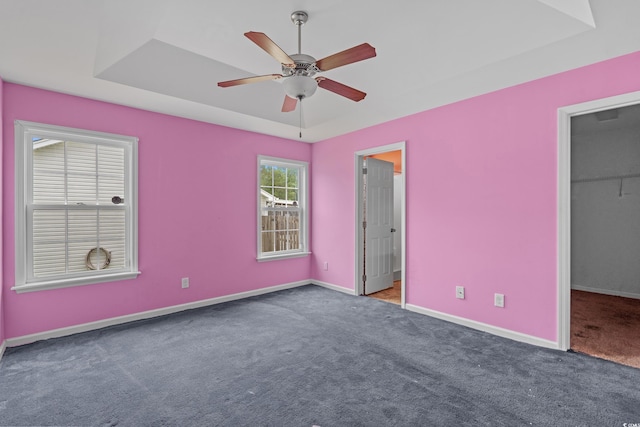 1220 Dunraven Ct, Conway, SC 29527 - unfurnished bedroom with carpet flooring, baseboards, a walk in closet, and a tray ceiling