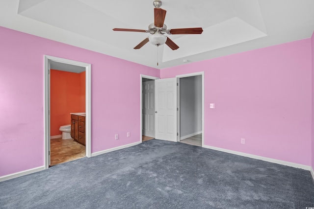 1220 Dunraven Ct, Conway, SC 29527 - unfurnished bedroom featuring carpet flooring, a tray ceiling, baseboards, connected bathroom, and ceiling fan