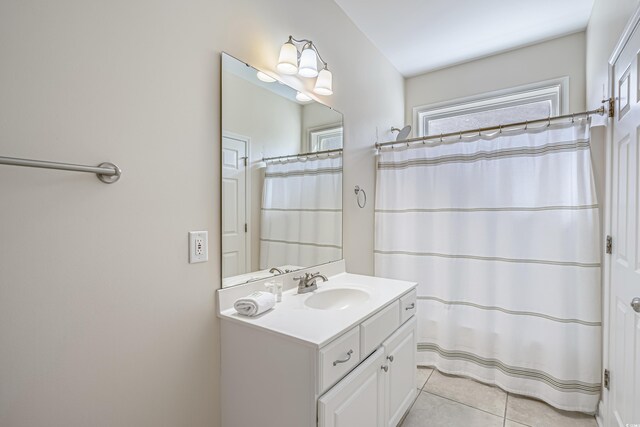 1613 Havens Dr, North Myrtle Beach, SC 29582 - full bath with vanity, plenty of natural light, tile patterned flooring, and a shower with curtain