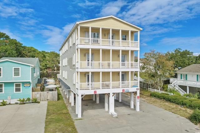 400 Hillside Dr S, North Myrtle Beach, SC 29582 - view of front facade with a balcony, concrete driveway, and a carport
