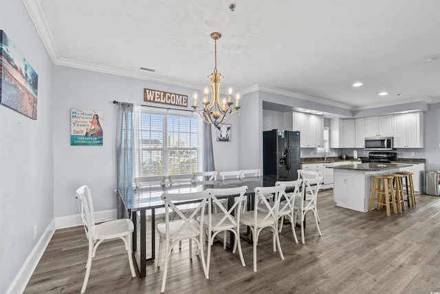 400 Hillside Dr S, North Myrtle Beach, SC 29582 - dining room with a chandelier, light wood finished floors, crown molding, recessed lighting, and baseboards