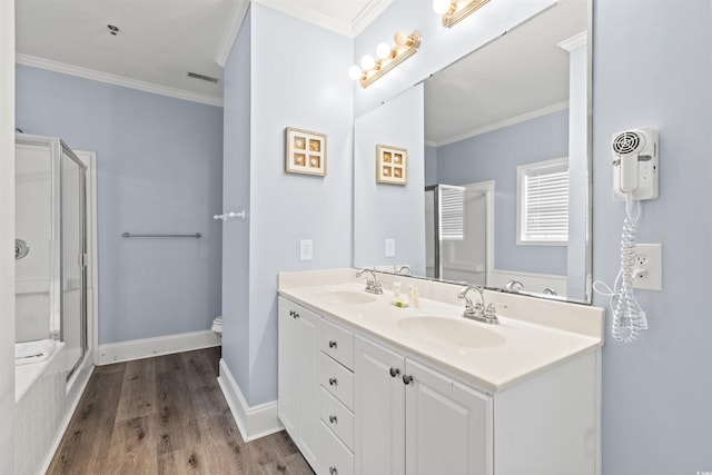 400 Hillside Dr S, North Myrtle Beach, SC 29582 - bathroom with crown molding, a stall shower, double vanity, wood finished floors, and toilet
