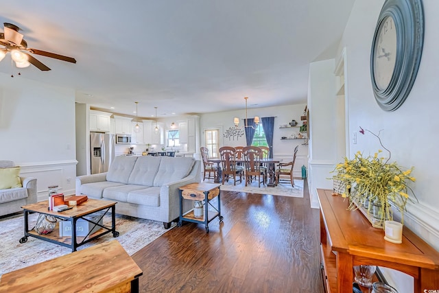 548 Fox Chase Dr, Conway, SC 29527 - living room featuring ceiling fan, dark wood-type flooring, a wainscoted wall, and a decorative wall