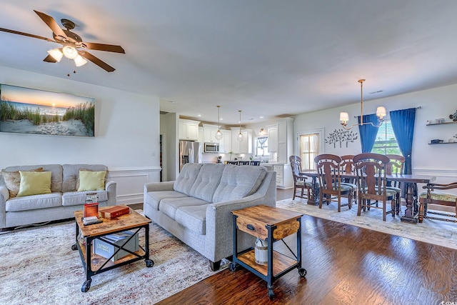 548 Fox Chase Dr, Conway, SC 29527 - living room with dark wood-type flooring, a chandelier, ceiling fan, wainscoting, and a decorative wall