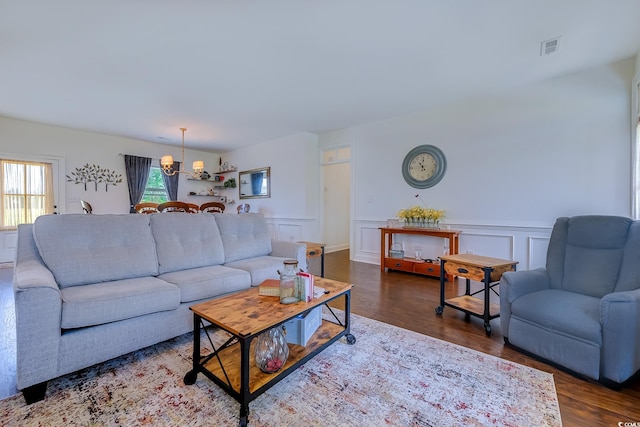 548 Fox Chase Dr, Conway, SC 29527 - living room with a chandelier, dark wood finished floors, a wainscoted wall, and a decorative wall
