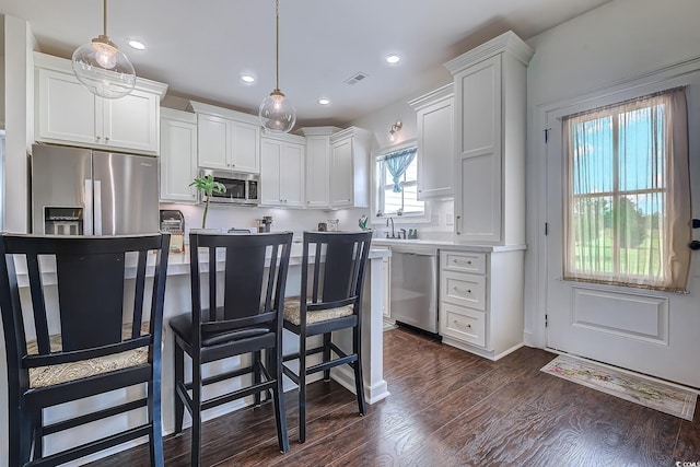 548 Fox Chase Dr, Conway, SC 29527 - kitchen featuring stainless steel appliances, white cabinets, dark wood finished floors, a sink, and recessed lighting