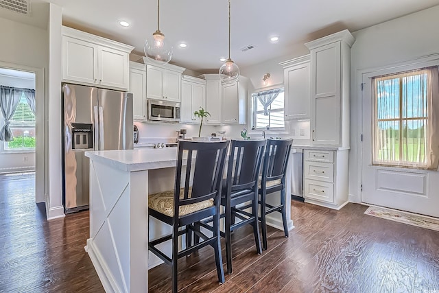 548 Fox Chase Dr, Conway, SC 29527 - kitchen with stainless steel appliances, light countertops, dark wood-type flooring, a breakfast bar area, and recessed lighting