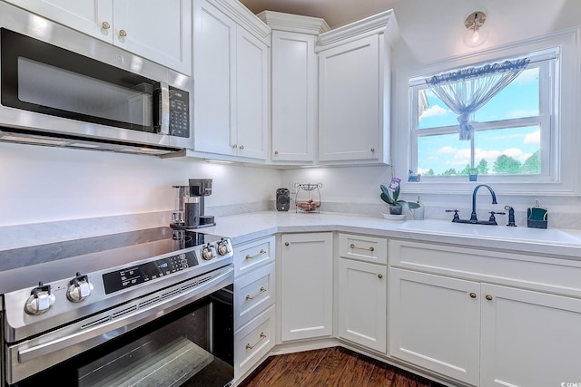 548 Fox Chase Dr, Conway, SC 29527 - kitchen featuring appliances with stainless steel finishes, light countertops, white cabinetry, a sink, and dark wood-style floors