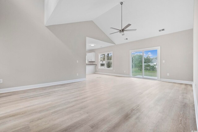 1900 Blue Bird Rd, Loris, SC 29569 - unfurnished living room with ceiling fan, high vaulted ceiling, and light wood-style floors