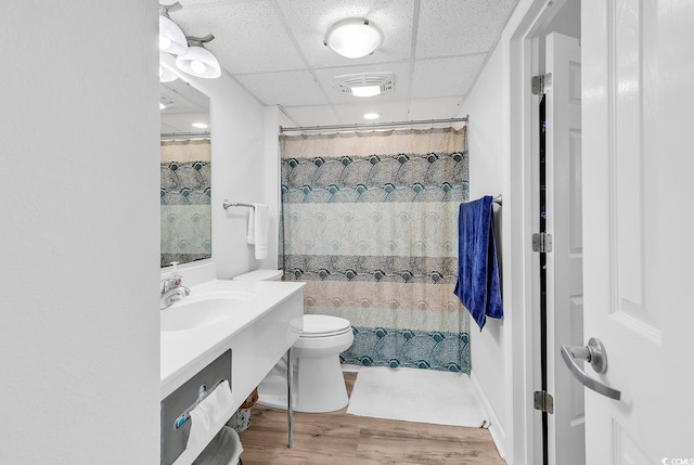 2501 S Ocean Blvd Unit 111, Myrtle Beach, SC 29577 - full bath with toilet, vanity, wood finished floors, a drop ceiling, and a shower with curtain