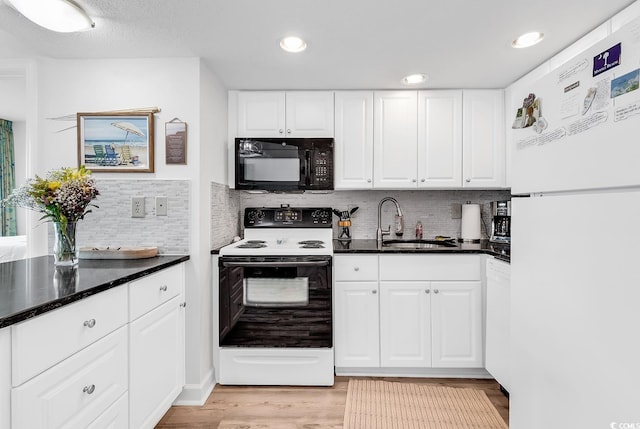 2501 S Ocean Blvd Unit 111, Myrtle Beach, SC 29577 - kitchen with white appliances, a sink, white cabinets, light wood-type flooring, and backsplash