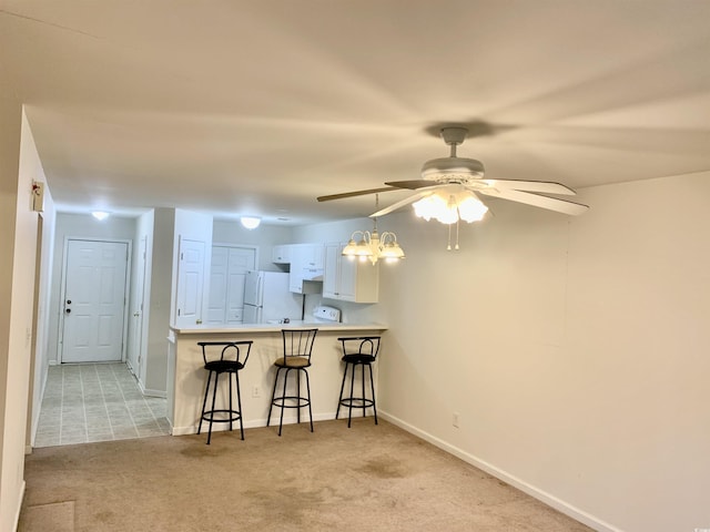 3677 Clay Pond Village Ln Unit 6, Myrtle Beach, SC 29579 - kitchen with freestanding refrigerator, a ceiling fan, light carpet, a breakfast bar area, and light countertops