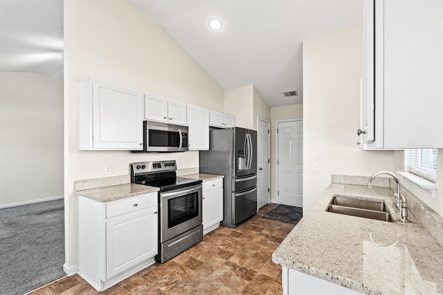 2336 Windmill Way, Myrtle Beach, SC 29579 - kitchen with appliances with stainless steel finishes, a sink, vaulted ceiling, white cabinets, and light stone countertops