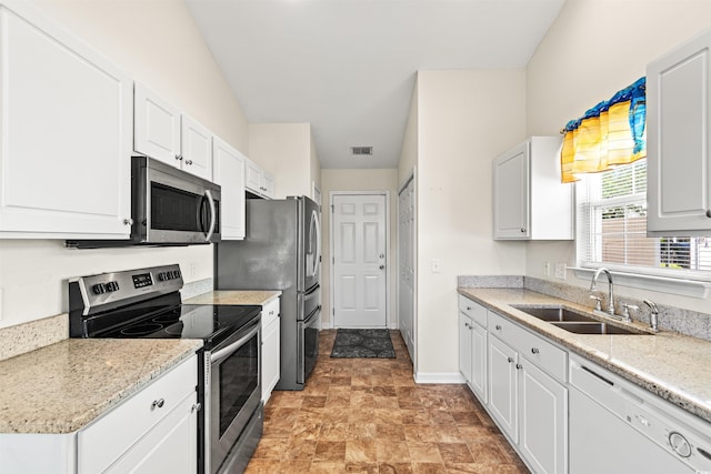 2336 Windmill Way, Myrtle Beach, SC 29579 - kitchen featuring stainless steel appliances, a sink, white cabinets, baseboards, and stone finish floors