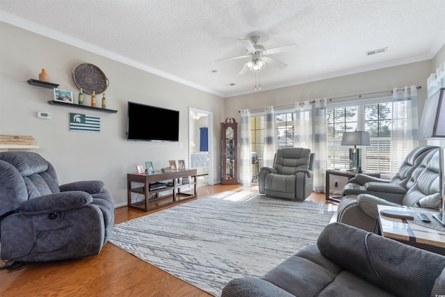5822 Longwood Dr Unit 104, Murrells Inlet, SC 29576 - living area with a ceiling fan, a textured ceiling, wood finished floors, crown molding, and baseboards