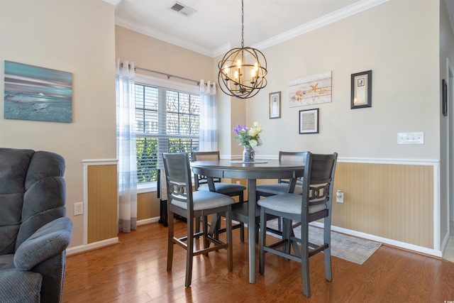 5822 Longwood Dr Unit 104, Murrells Inlet, SC 29576 - dining space with wood finished floors, crown molding, a chandelier, wainscoting, and baseboards