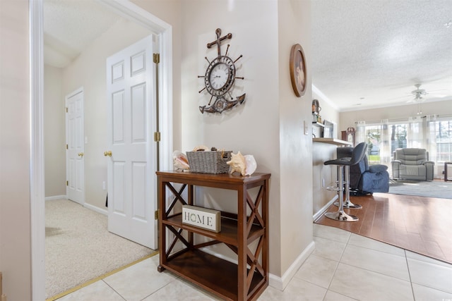 5822 Longwood Dr Unit 104, Murrells Inlet, SC 29576 - corridor featuring a textured ceiling, tile patterned flooring, and baseboards