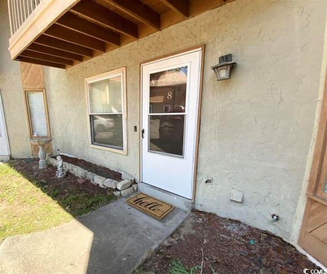 600 65th Ave N Unit 8, Myrtle Beach, SC 29572 - view of exterior entry featuring stucco siding