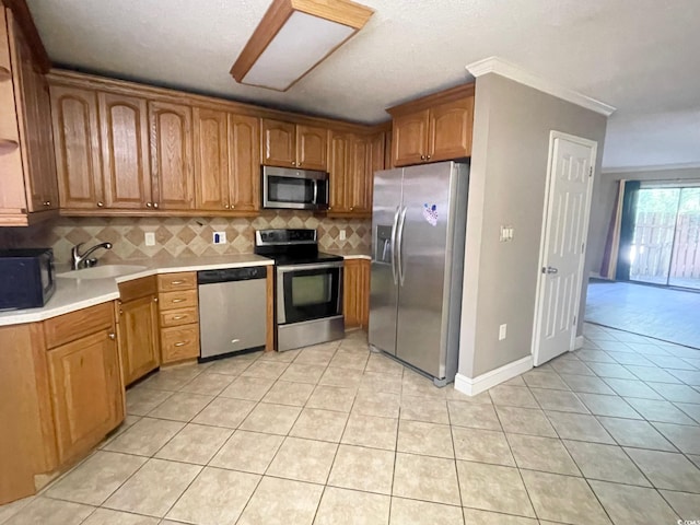 600 65th Ave N Unit 8, Myrtle Beach, SC 29572 - kitchen with stainless steel appliances, a sink, backsplash, light tile patterned flooring, and light countertops