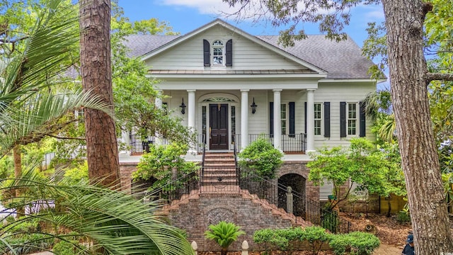 1080 Waterway Ln, Myrtle Beach, SC 29572 - neoclassical / greek revival house featuring covered porch, stairs, and roof with shingles