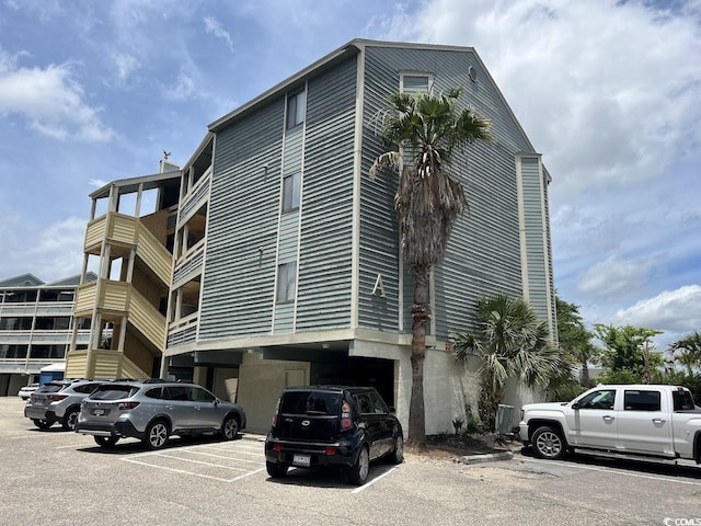1101 Possum Trot Rd Unit A202, North Myrtle Beach, SC 29582 - view of building exterior featuring uncovered parking