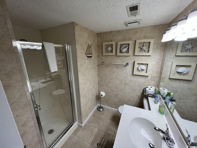 1101 Possum Trot Rd Unit A202, North Myrtle Beach, SC 29582 - bathroom with a shower stall, tile patterned flooring, a textured ceiling, and vanity