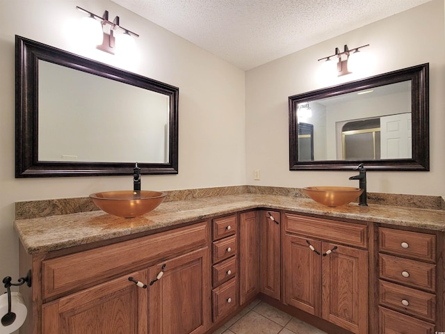 3904 Williamson Cir, Myrtle Beach, SC 29579 - bathroom with double vanity, a textured ceiling, and tile patterned floors