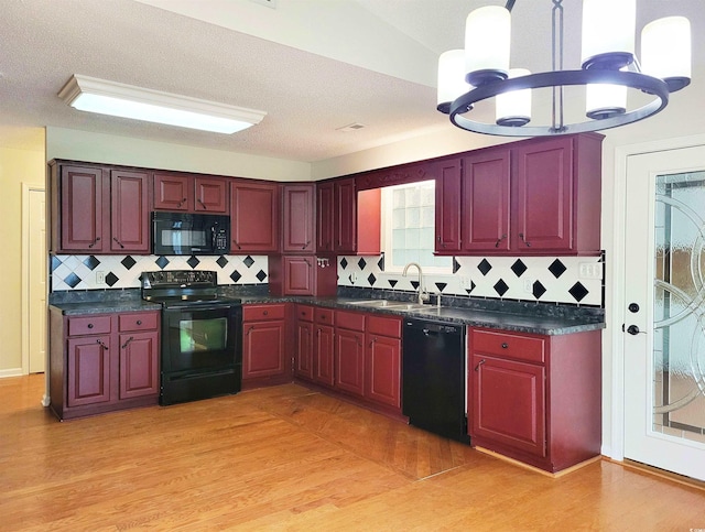 3904 Williamson Cir, Myrtle Beach, SC 29579 - kitchen with black appliances, a sink, reddish brown cabinets, dark countertops, and backsplash