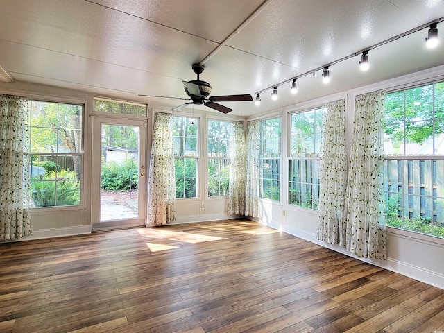 3904 Williamson Cir, Myrtle Beach, SC 29579 - unfurnished sunroom featuring hardwood / wood-style floors, a deck, rail lighting, and baseboards
