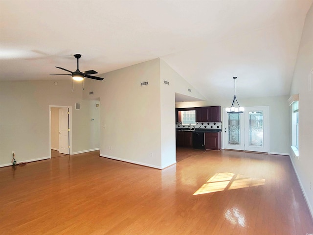 3904 Williamson Cir, Myrtle Beach, SC 29579 - unfurnished living room featuring lofted ceiling, light wood-type flooring, a ceiling fan, baseboards, and a chandelier
