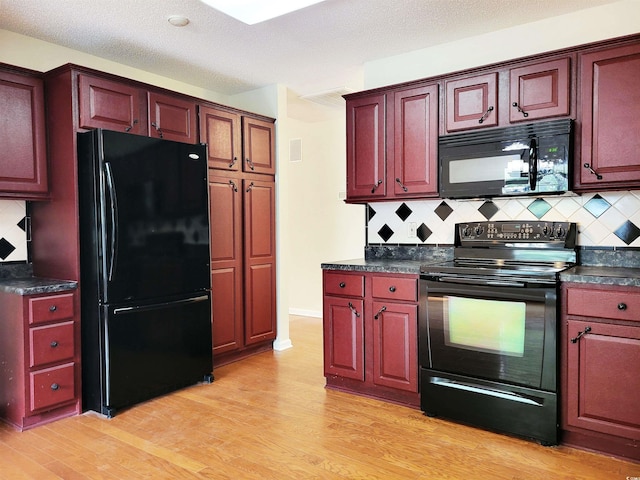 3904 Williamson Cir, Myrtle Beach, SC 29579 - kitchen featuring black appliances, dark countertops, decorative backsplash, and light wood-style flooring