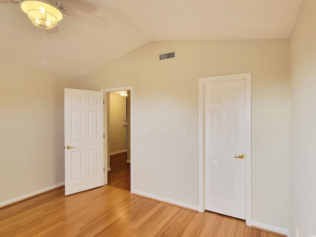 3904 Williamson Cir, Myrtle Beach, SC 29579 - unfurnished bedroom featuring light wood-style flooring, baseboards, and lofted ceiling
