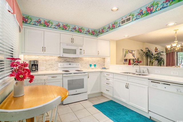 213 Westleton Dr Unit 16B, Myrtle Beach, SC 29572 - kitchen featuring white appliances, white cabinets, a chandelier, light countertops, and backsplash