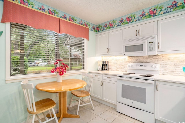 213 Westleton Dr Unit 16B, Myrtle Beach, SC 29572 - kitchen featuring white appliances, light countertops, white cabinets, and a textured ceiling