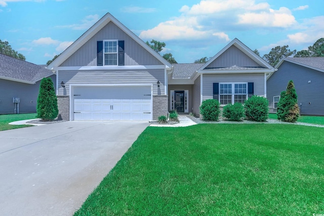 617 Chiswick Dr, Conway, SC 29526 - view of front facade with a front yard, concrete driveway, a garage, and board and batten siding