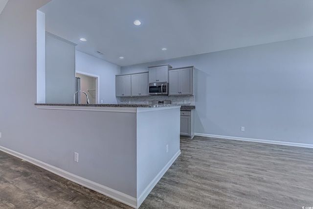 617 Chiswick Dr, Conway, SC 29526 - kitchen featuring stainless steel microwave, baseboards, backsplash, wood finished floors, and recessed lighting