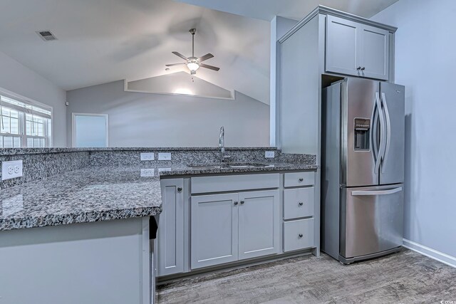 617 Chiswick Dr, Conway, SC 29526 - kitchen featuring stainless steel fridge with ice dispenser, a sink, a ceiling fan, light wood-type flooring, and dark stone counters