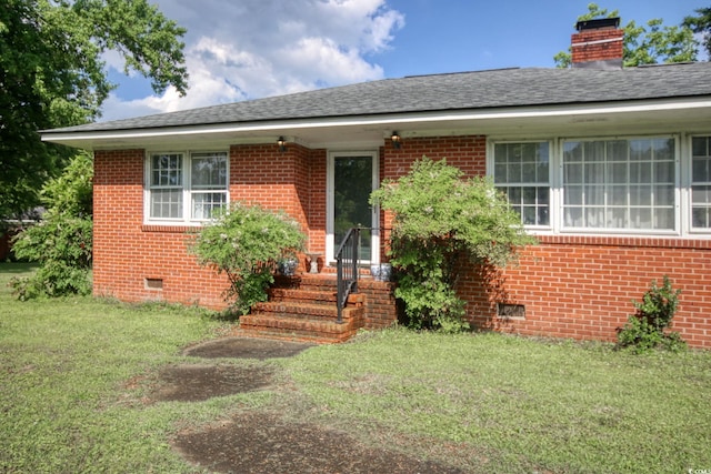 2004 Seitter St, Georgetown, SC 29440 - view of front of house featuring crawl space, brick siding, and a front lawn