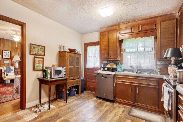 2004 Seitter St, Georgetown, SC 29440 - kitchen featuring appliances with stainless steel finishes, a textured ceiling, light wood finished floors, tasteful backsplash, and light countertops