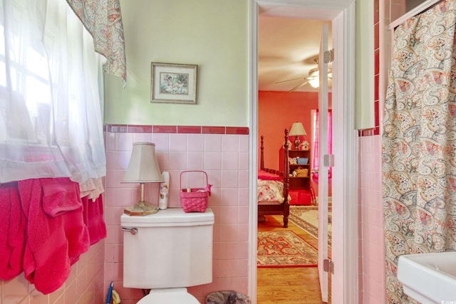 2004 Seitter St, Georgetown, SC 29440 - full bath featuring tile walls, ceiling fan, a wainscoted wall, wood finished floors, and a shower with curtain